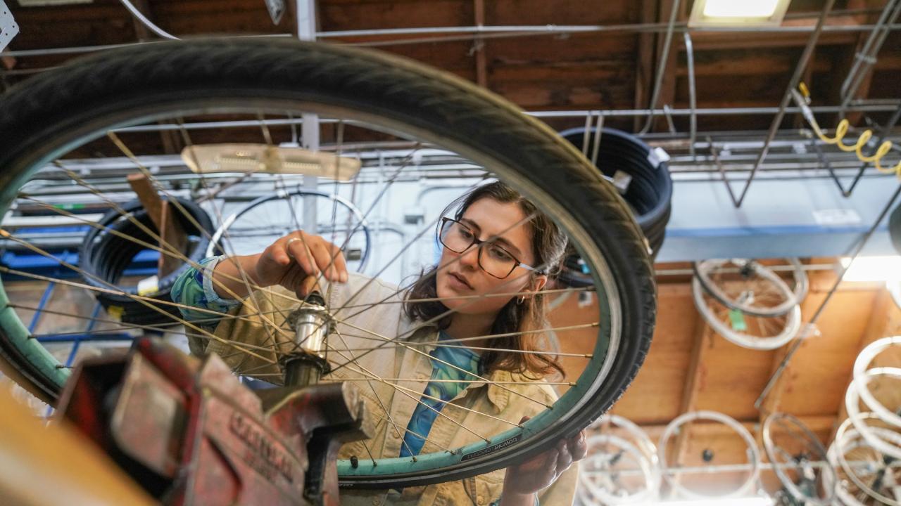 Student working on a bike in the bike barn