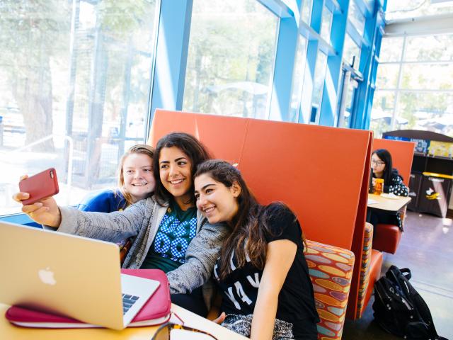 Students taking group selfie in the MU