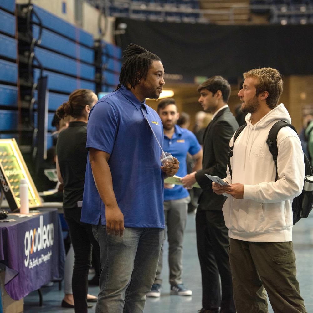 A student speaks with a potential employer at the career fair